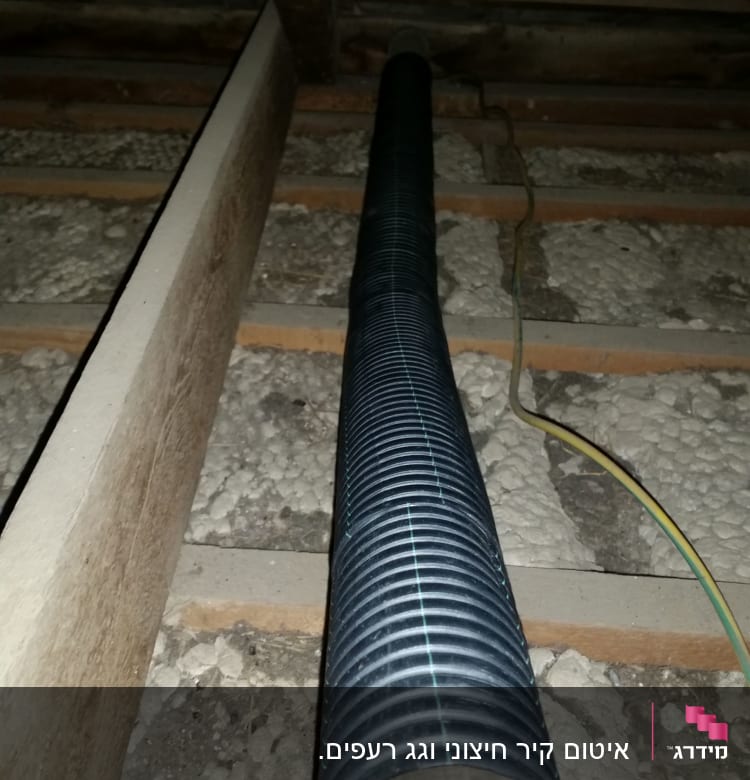 צינור גמיש מתחת לגג רעפים עם קורות עץ